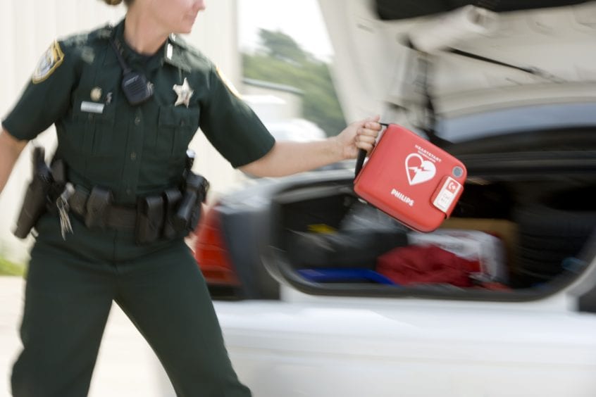 Law Enforcement Police Woman Holding HeartStart